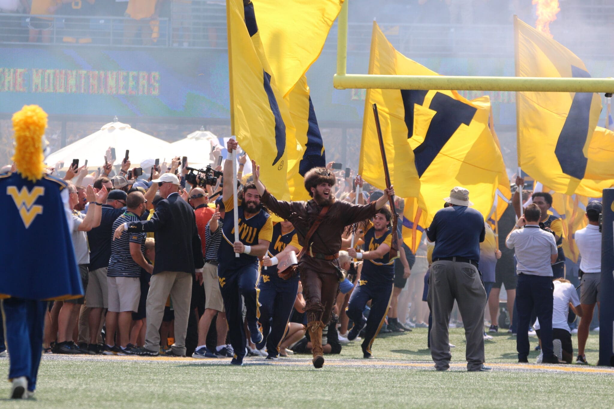 WVU Mountaineer Mascot runs on field before WVU Football game stock