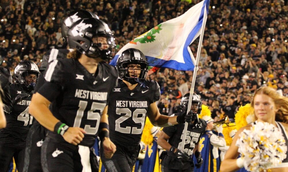 WVU Football WR Preston Fox with flag before Coal Rush game