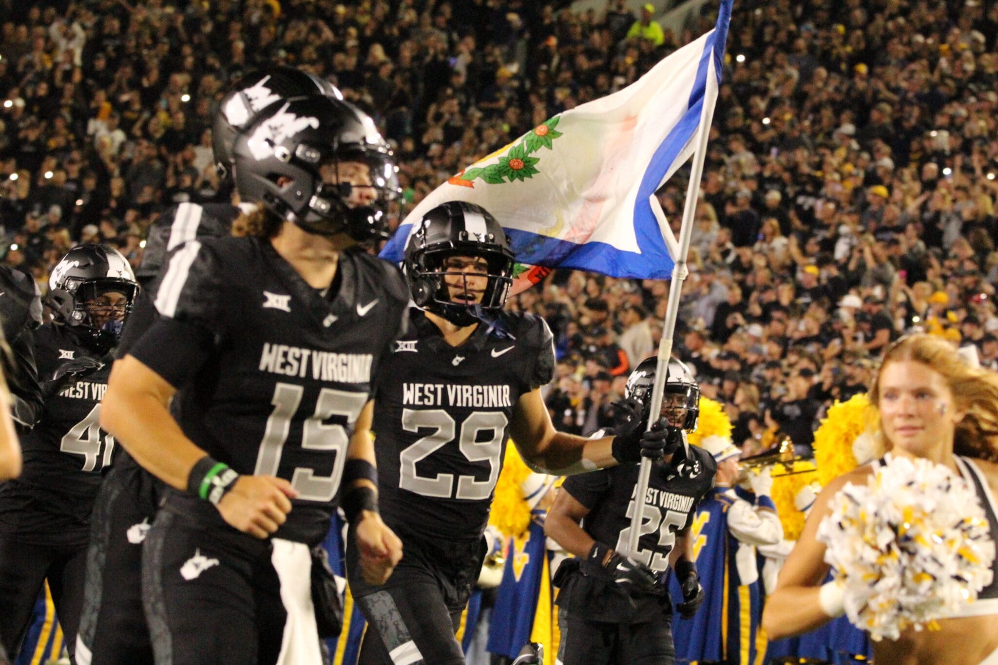WVU Football WR Preston Fox with flag before Coal Rush game