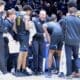 WVU Basketball HC Darian DeVries in WVU basketball huddle