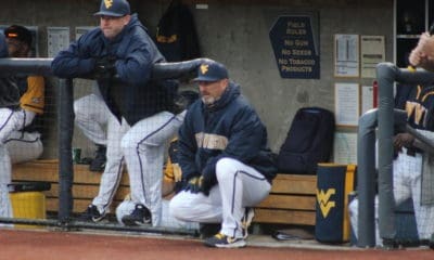 WVU Baseball head coach Randy Mazey watches from the dugout during a game.