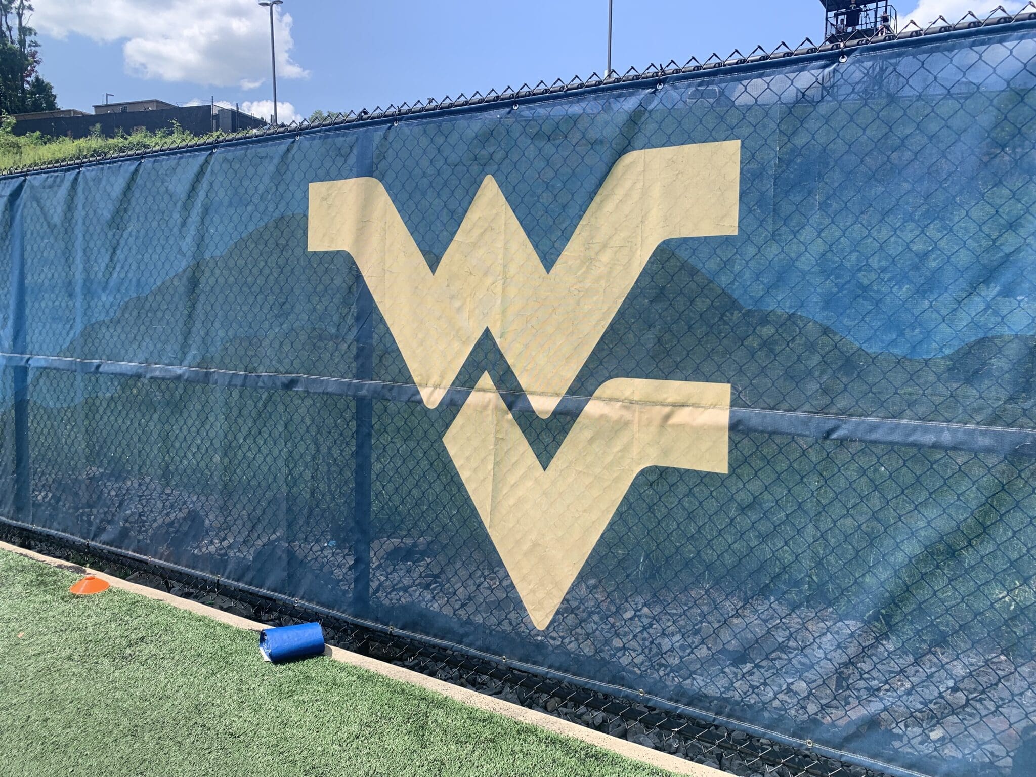 WVU Football stock logo on practice field wall