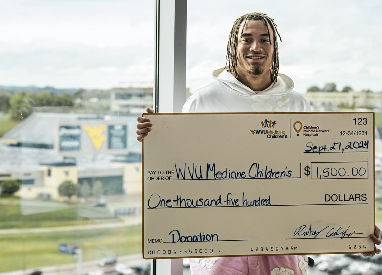 Rodney Gallagher with check at hospital