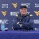 WVU Football HC Rich Rodriguez laughing
