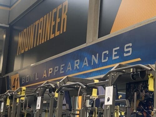 WVU Football bowl appearances on wall of weight room
