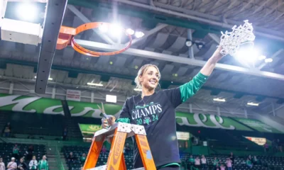 Kim Caldwell holding net after winning conference title with Marshall