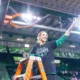 Kim Caldwell holding net after winning conference title with Marshall