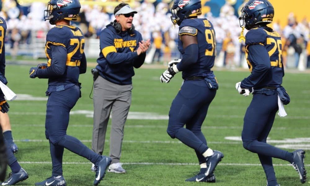 Neal Brown with WVU Football team