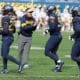 Neal Brown with WVU Football team