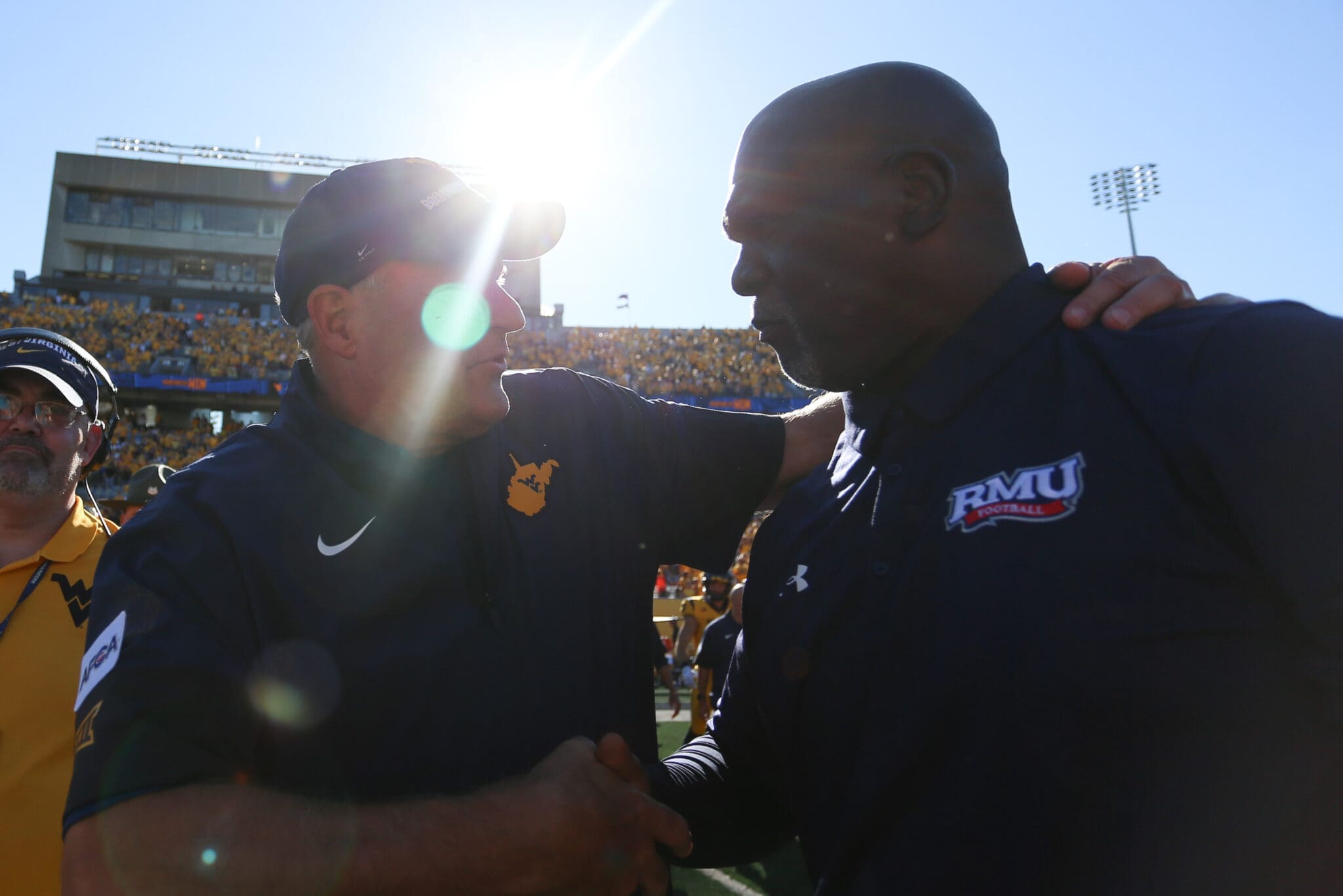 WVU Football HC Rich Rodriguez shakes hands with RMU head coach after season opening win