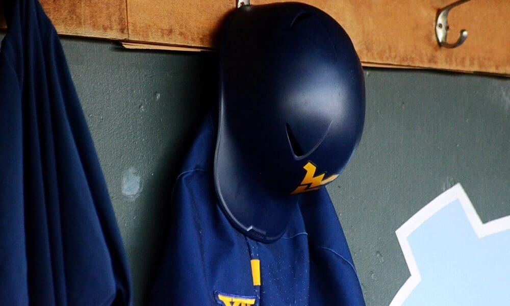 A WVU helmet hangs in the dugout as the Mountaineers played against North Carolina on June 8, 2024, in the Super Regionals of the NCAA Tournament at Boshamer Stadium in Chapel Hill, N.C. (Mitchell Northam / WV Sports Now)