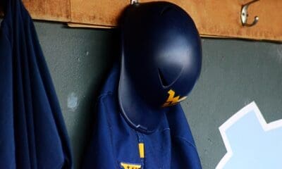 A WVU helmet hangs in the dugout as the Mountaineers played against North Carolina on June 8, 2024, in the Super Regionals of the NCAA Tournament at Boshamer Stadium in Chapel Hill, N.C. (Mitchell Northam / WV Sports Now)