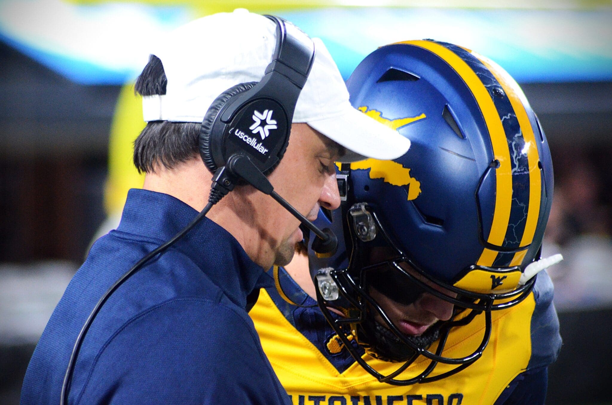 WVU quarterback Garrett Greene talks to head coach Neal Brown before taking the field against UNC in the Duke's Mayo Bowl at Bank of America Stadium in Charlotte, N.C. on Dec. 27, 2023. (Mitchell Northam / WV Sports Now)