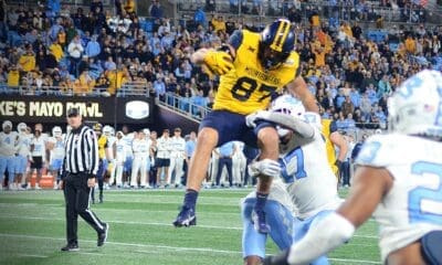 WVU Football tight end Kole Taylor attempts to hurdle a UNC defender in the Duke's Mayo Bowl at Bank of America Stadium in Charlotte, N.C. on Dec. 27, 2023. (Mitchell Northam / WV Sports Now)