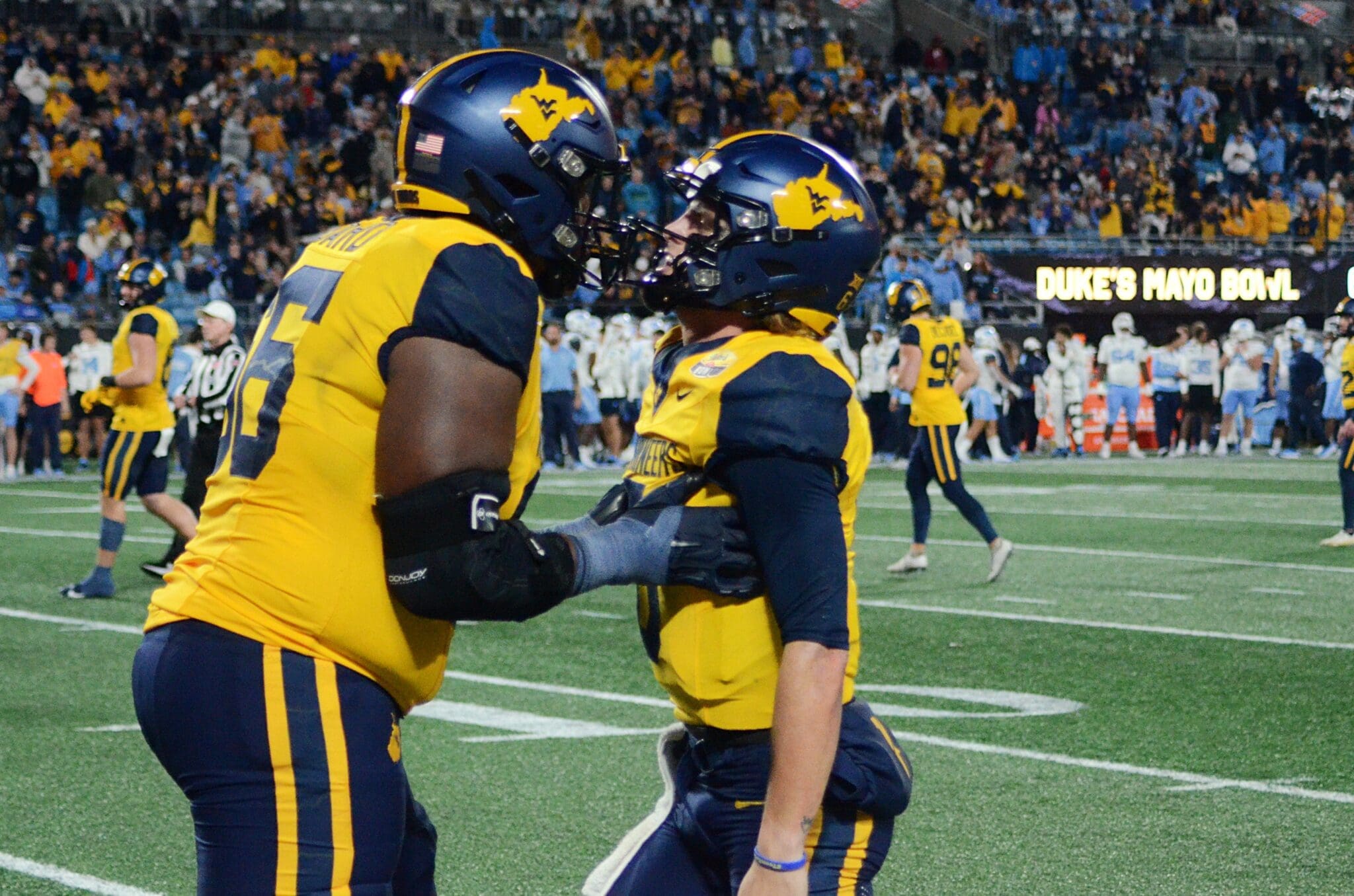 WVU Football Ja'Quay Hubbard and Garrett Greene celebrate a touchdown against UNC in the Duke's Mayo Bowl at Bank of America Stadium in Charlotte, N.C. on Dec. 27, 2023. (Mitchell Northam / WV Sports Now)