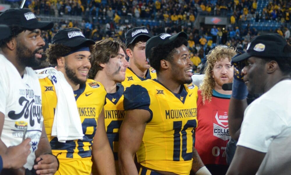 Jared Bartlett and WVU players celebrate beating UNC in the Duke's Mayo Bowl at Bank of America Stadium in Charlotte, N.C. on Dec. 27, 2023. (Mitchell Northam / WV Sports Now)