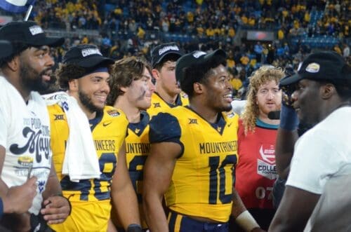 Jared Bartlett and WVU players celebrate beating UNC in the Duke's Mayo Bowl at Bank of America Stadium in Charlotte, N.C. on Dec. 27, 2023. (Mitchell Northam / WV Sports Now)