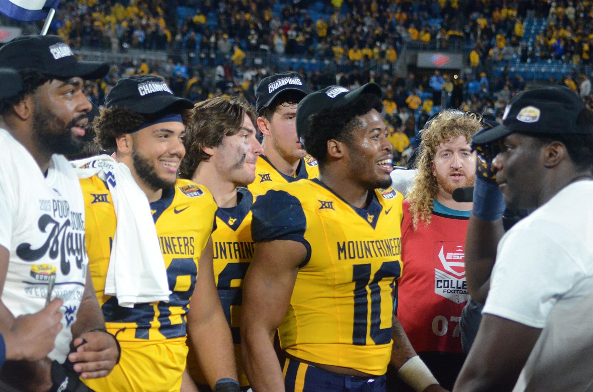 Jared Bartlett and WVU players celebrate beating UNC in the Duke's Mayo Bowl at Bank of America Stadium in Charlotte, N.C. on Dec. 27, 2023. (Mitchell Northam / WV Sports Now)