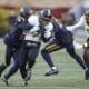 WVU Football safety Anthony Wilson tackles RJ Harvey