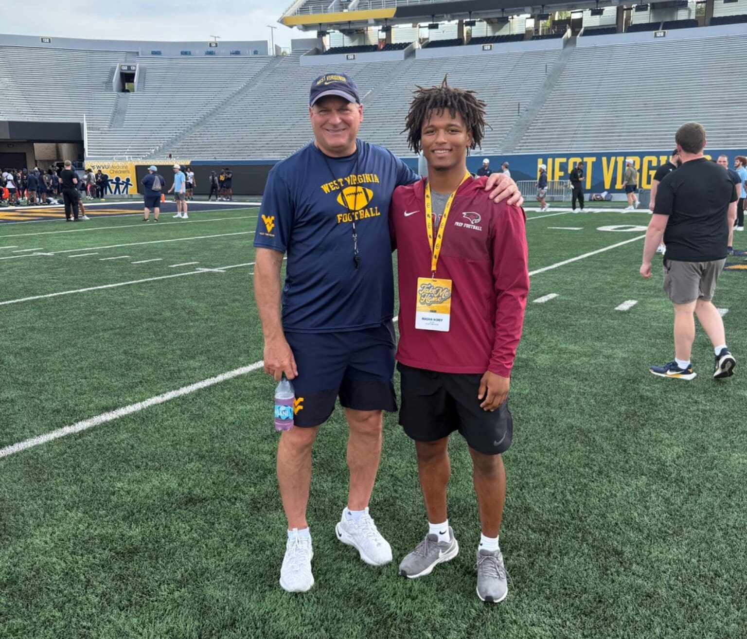 WVU Football HC Rich Rodriguez with CB recruit Masaii Acrey