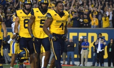 WVU Football Nicco Marchiol, CJ Donaldson with helmet off and Devin Carter