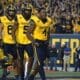 WVU Football Nicco Marchiol, CJ Donaldson with helmet off and Devin Carter