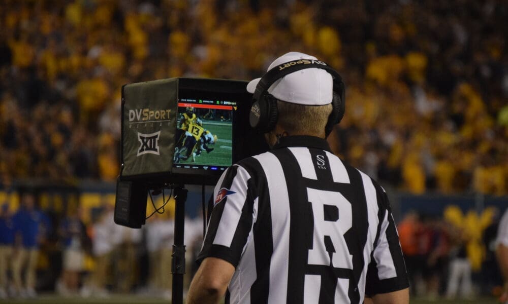 Big 12 ref looking at replay during WVU Football game