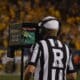 Big 12 ref looking at replay during WVU Football game